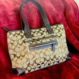 Coach bag beige background with chocolate brown leather and signature C